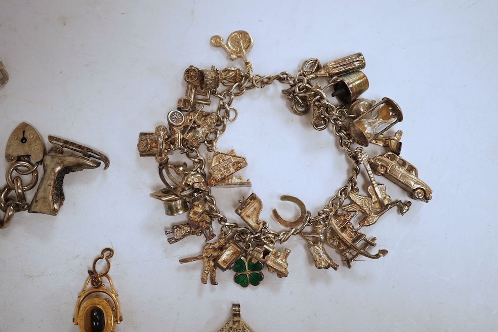 A white metal hunter keywind pocket watch, with Roman dial and subsidiary seconds, two silver charm bracelets and sundry items including jewellery and a silver sovereign case.